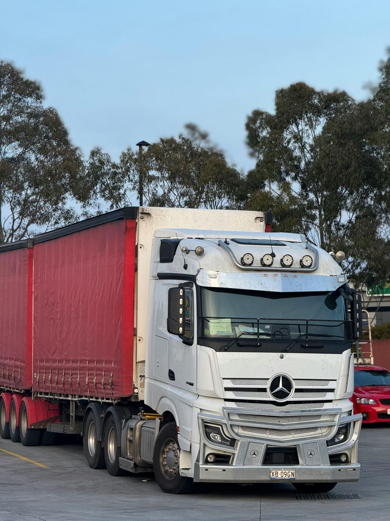 White Mercedes truck with trailer