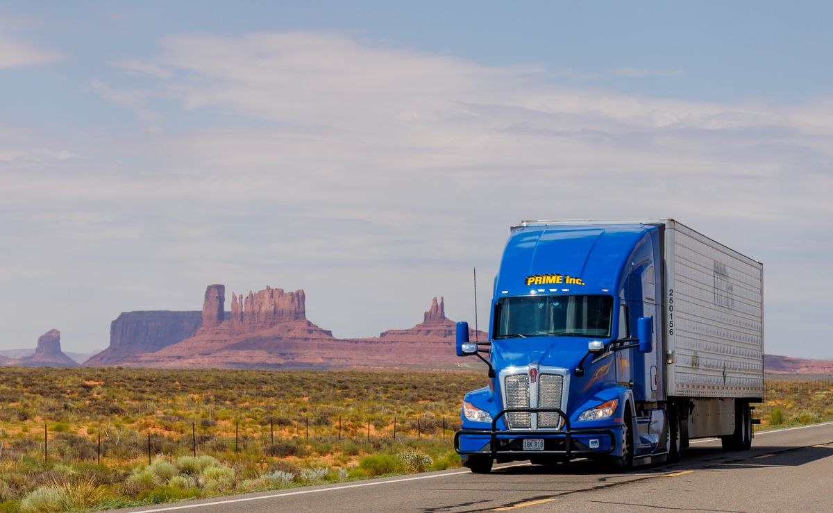 Commercial semi-truck hauling freight across the open highway