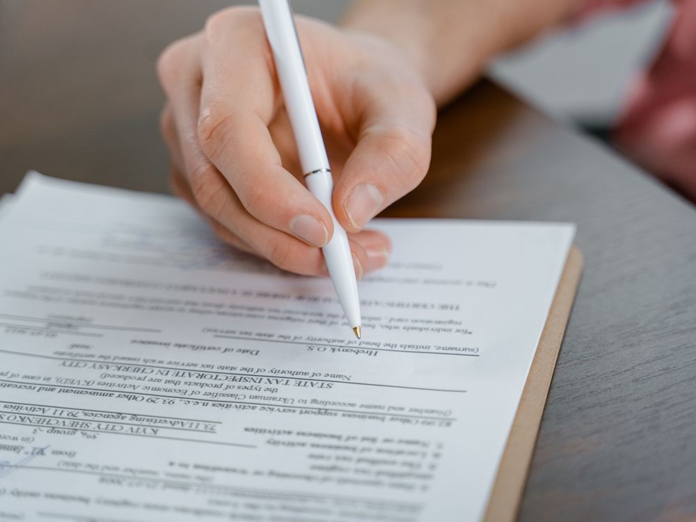 Signing an insurance policy with a pen