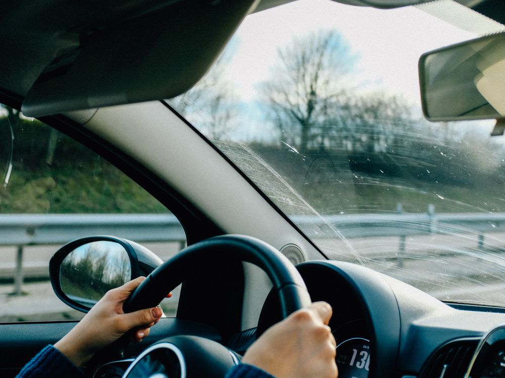 Driver behind the wheel on an open road