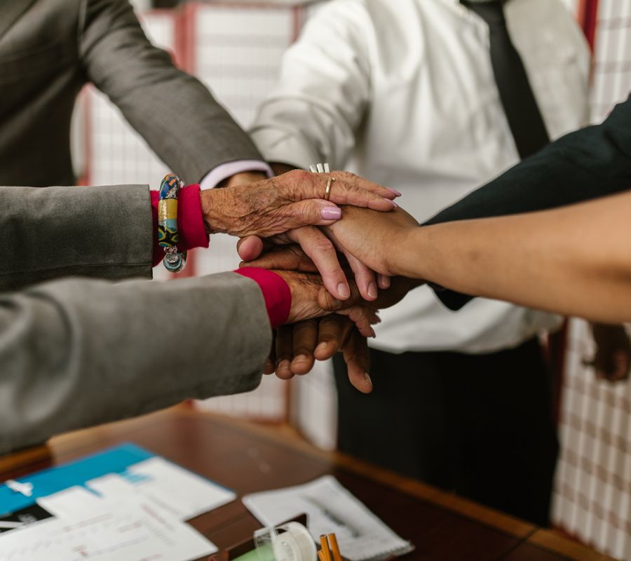 Business team putting their hands together