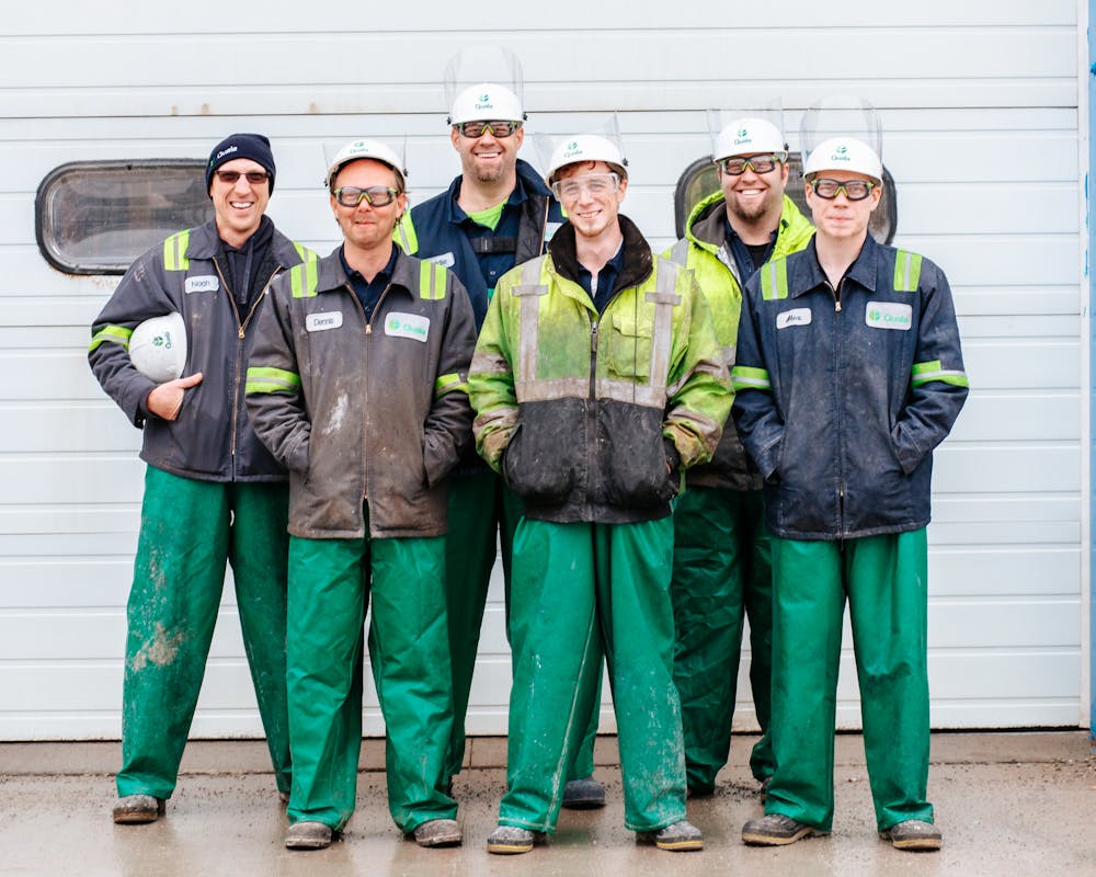 Team of workers in hard hats and safety gear